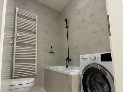 a bathroom with a washing machine and a toilet at Luxurious Studio Apartment Vyšehrad in Prague