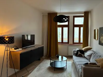 a living room with a couch and a tv at Luxurious Studio Apartment Vyšehrad in Prague