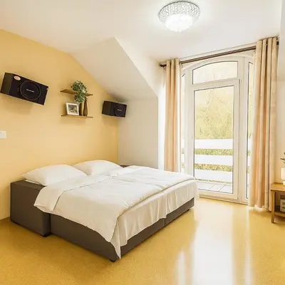 a bedroom with a bed and a large window at Dream House Prague East in Kamenice