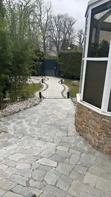 a stone walkway in front of a house at Dream House Prague East in Kamenice