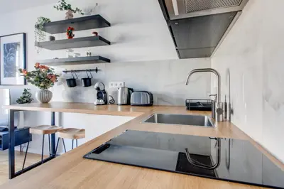 a kitchen with a sink and a counter at Ječná Stylish Residence - Charles Square, Old town in Prague
