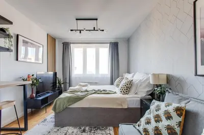 a bedroom with a bed and a couch at Ječná Stylish Residence - Charles Square, Old town in Prague