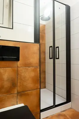 a shower with a glass door in a bathroom at Apartmán IRIS Poděbrady 3 in Poděbrady