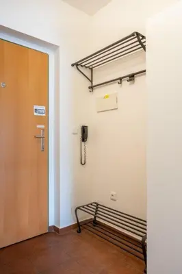 an empty room with a bench and a phone at Apartmán IRIS Poděbrady 3 in Poděbrady