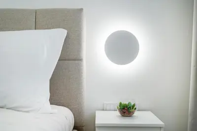 a room with a bed and a table with a pillow at Rentero Warm and Bright Apartment at Prague in Prague