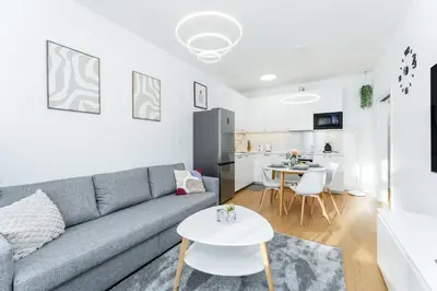a living room with a couch and a table at Rentero Warm and Bright Apartment at Prague in Prague