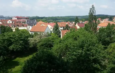 a view of a city with houses and trees at Veles Apartment in Prague