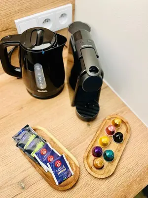 a table with a coffee maker and some donuts and a coffee pot at Studio above the Muzeum in Prague