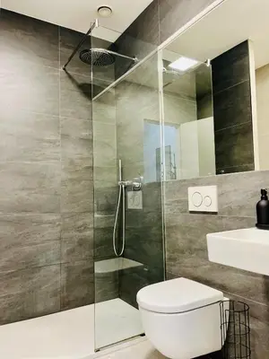 a bathroom with a shower and a toilet and a sink at Studio above the Muzeum in Prague