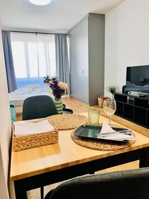 a room with a table and a room with a bed at Studio above the Muzeum in Prague
