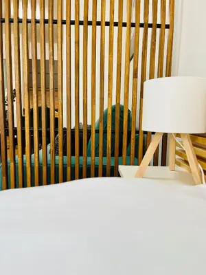 a bird in a cage next to a lamp at Studio above the Muzeum in Prague