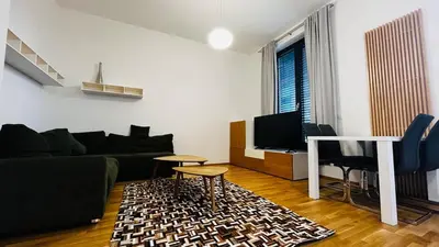 a living room with a couch and a table at Apartment Holesovice, garden, garage in Prague