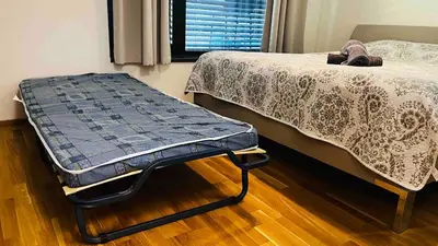 a bed sitting in a room next to a window at Apartment Holesovice, garden, garage in Prague