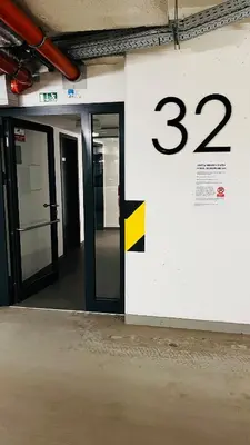 an open door in a building with a sign at Apartment Holesovice, garden, garage in Prague