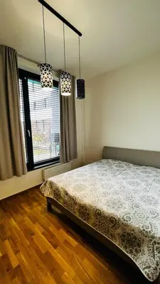 a bedroom with a bed and a window at Apartment Holesovice, garden, garage in Prague