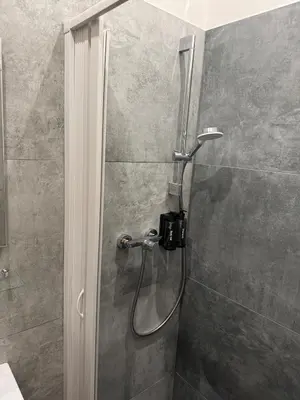 a shower with a glass door in a bathroom at Diamond suite in Prague