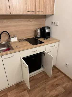 a small kitchen with a sink and a microwave at Diamond suite in Prague