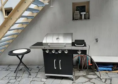 a kitchen with a stove and a stool next to a staircase at Prague Luxury Apartment in Prague
