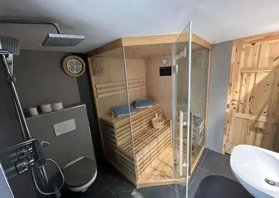 a bathroom with a shower and a toilet and a sink at Prague Luxury Apartment in Prague