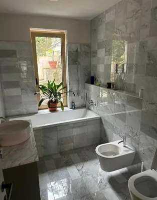 a bathroom with a tub and a toilet and a sink at Prague Luxury Apartment in Prague