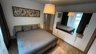 a small bedroom with a bed and a mirror at Residence Garden Tower - 8 min do centra, garaz in Prague