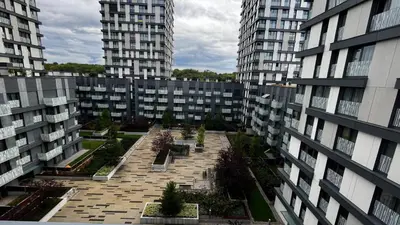 a view of a courtyard in a building with tall buildings at Residence Garden Tower - 8 min do centra, garaz in Prague