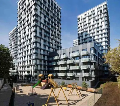 two tall buildings with a playground in front of a building at Residence Garden Tower - 8 min do centra, garaz in Prague