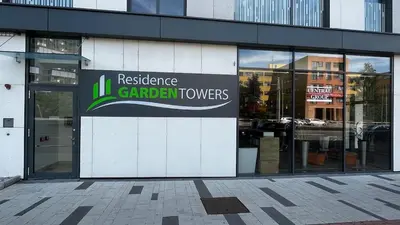 a building with a sign on the side of it at Residence Garden Tower - 8 min do centra, garaz in Prague