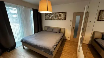 a bedroom with a bed and a large window at Residence Garden Tower - 8 min do centra, garaz in Prague