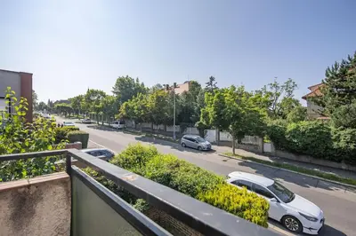 a view of a street with cars parked on the road at Spacious House with Garden 15 min walk from Castle in Prague