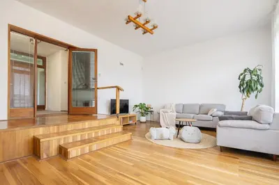 a living room with a staircase and a couch at Spacious House with Garden 15 min walk from Castle in Prague