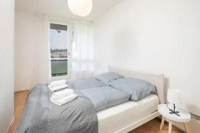 a white bedroom with a bed and a window at Spacious House with Garden 15 min walk from Castle in Prague
