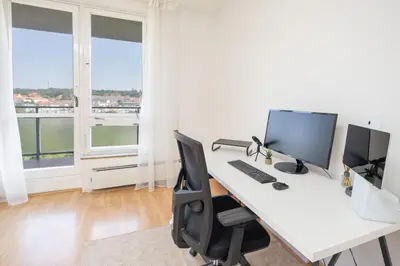 an office with a desk with a computer on it at Spacious House with Garden 15 min walk from Castle in Prague