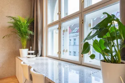 a dining room with a glass table and plants at Residence near the Old Town Square in Prague