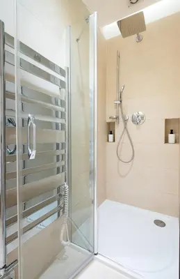 a shower with a glass door in a bathroom at Residence near the Old Town Square in Prague