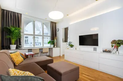 a living room with a couch and a flat screen tv at Residence near the Old Town Square in Prague