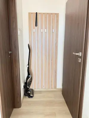 a small room with a wooden table and a small refrigerator at Apartmán ve Zlonicích blízko Prahy in Zlonice