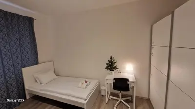 a small room with a white bed and a desk at Fully renovated apartment by Anděl metro in Prague