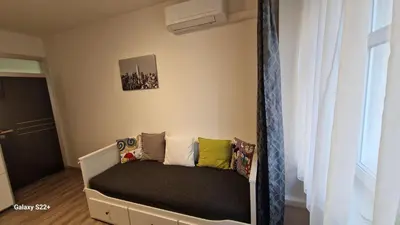 a small bed in a room with a window at Fully renovated apartment by Anděl metro in Prague