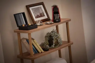 a wooden shelf with a cell phone on top of it at U Šuterů Boutique Hotel in Prague