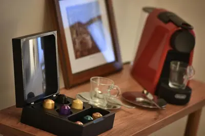 a wooden table with a television and a box of food at U Šuterů Boutique Hotel in Prague