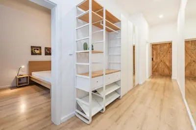 a room with a white book shelf and a bed at Apartment Vinohradská 14 in Prague