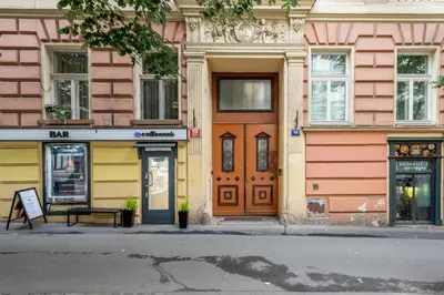 a row of colorful buildings on a city street at Apartment Vinohradská 14 in Prague