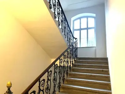 a staircase in a house with a window at Small studio with loft bed in Prague