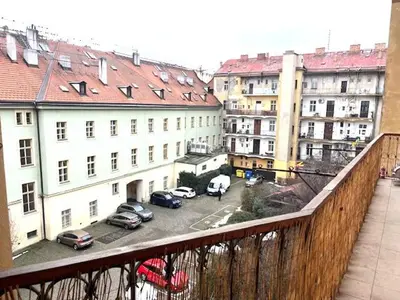 a view of a city with cars parked in a parking lot at Small studio with loft bed in Prague