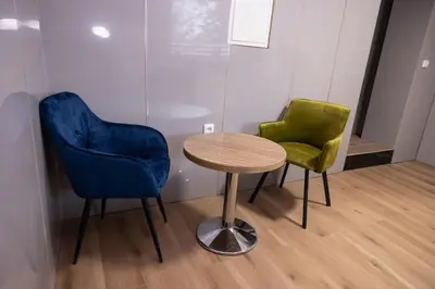 two chairs and a table in a room at Novohome in Prague