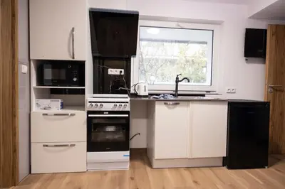 a kitchen with white appliances and a window at Novohome in Prague