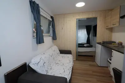 a living room with a couch and a kitchen at Novohome in Prague