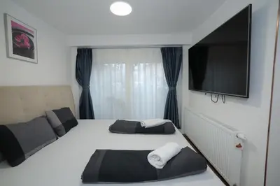 a bedroom with two beds and a flat screen tv at Novohome in Prague