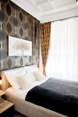 a bedroom with a large bed and a window at Royal Apart in Prague